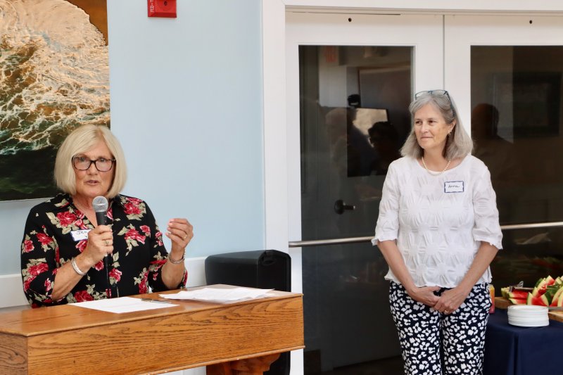 Jennifer VanBlarcom, Village Volunteers board president, left, and Anna Moshier, Village Volunteers executive director, talk about Finer’s lasting legacy during the April 4 celebration of life.